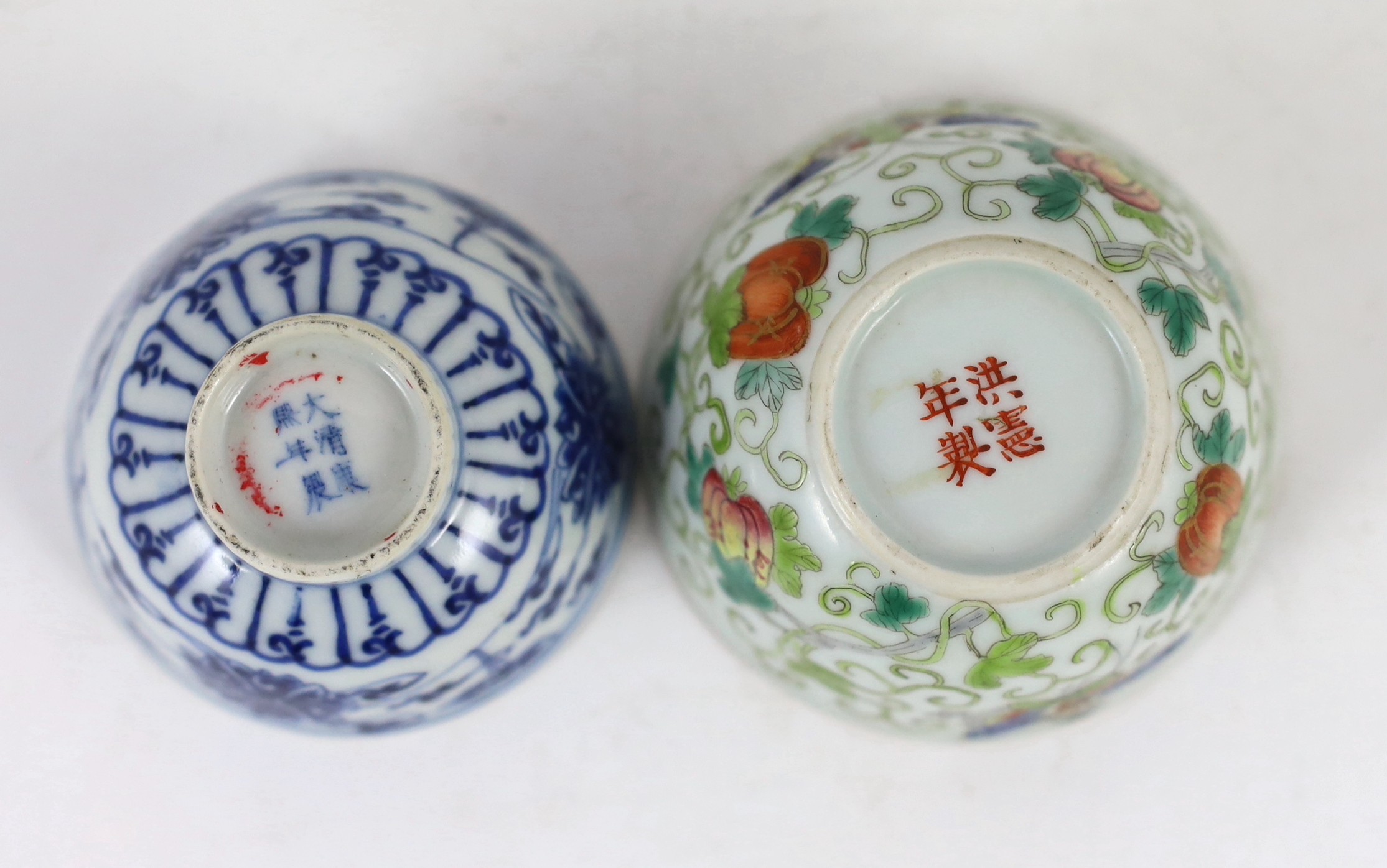 A Chinese enamelled porcelain ‘butterfly and melon’ cup, Republic period and a Chinese blue and white ‘lotus’ cup, late 19th century, (2)